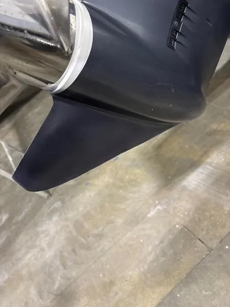 Slide: The Image of 2022 Key West 219fs boat propeller detail on a wooden floor. - 2