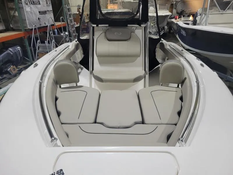 Slide: The Image of 2022 Key West 219fs boat interior with cushioned seating and storage compartments. - 4