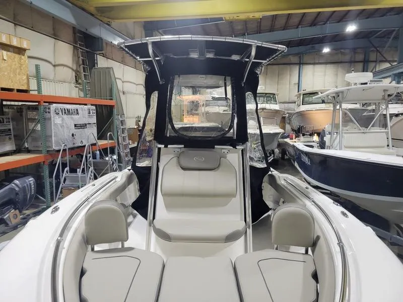 Slide: The Image of 2022 Key West 219fs boat interior in a showroom with seating and canopy. - 6