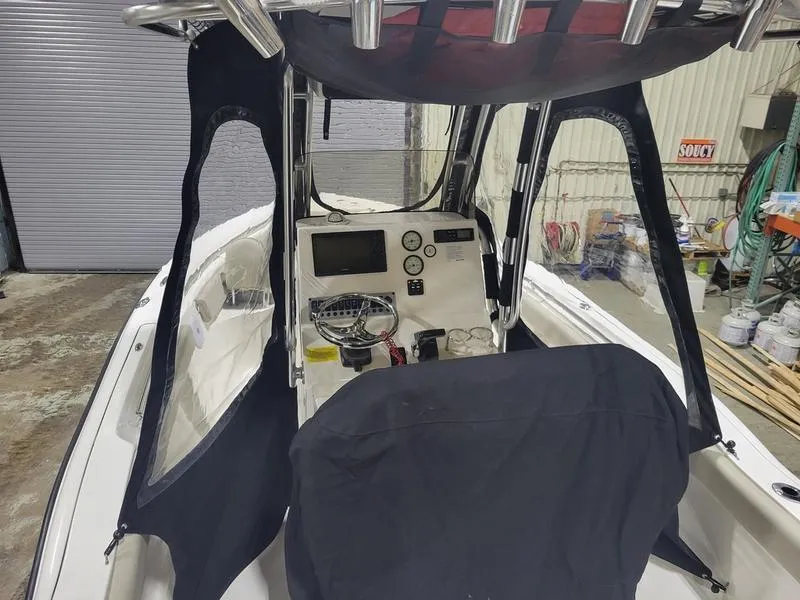 Slide: The Image of 2022 Key West 219fs boat interior with console and protective cover. - 9