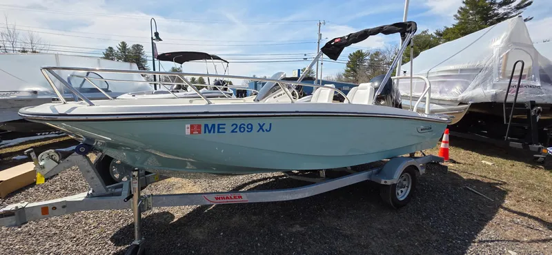 Slide: The Image of 2024 Boston Whaler 160 Super Sport boat on trailer, parked outdoors. - 11