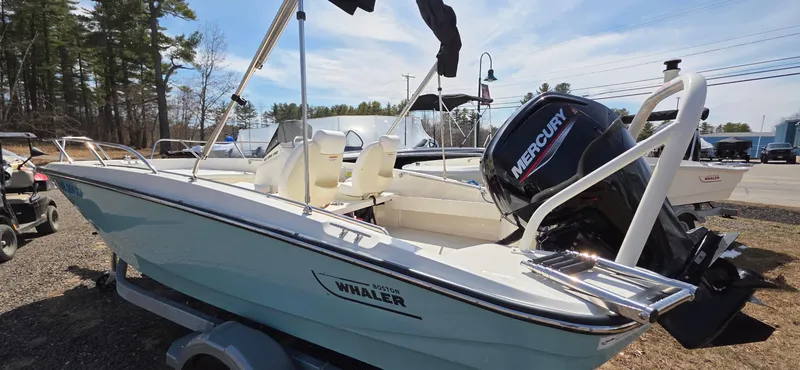 Slide: The Image of 2024 Boston Whaler 160 Super Sport boat with Mercury engine, parked outdoors. - 12