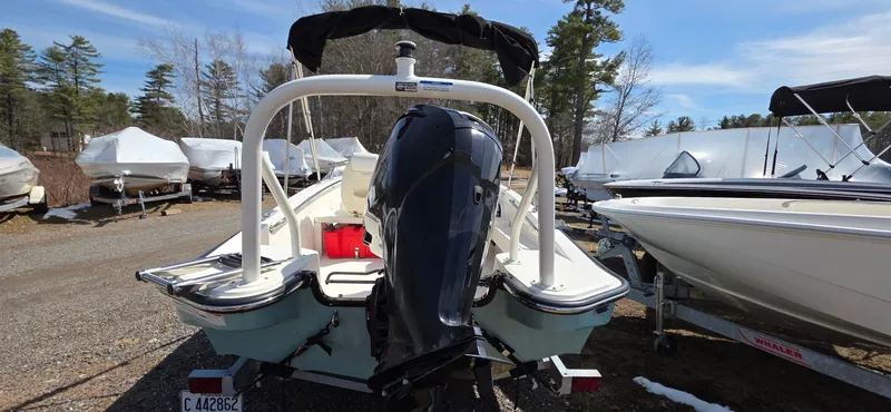 Slide: The Image of 2024 Boston Whaler 160 Super Sport boat, rear view, parked outdoors with other boats. - 13