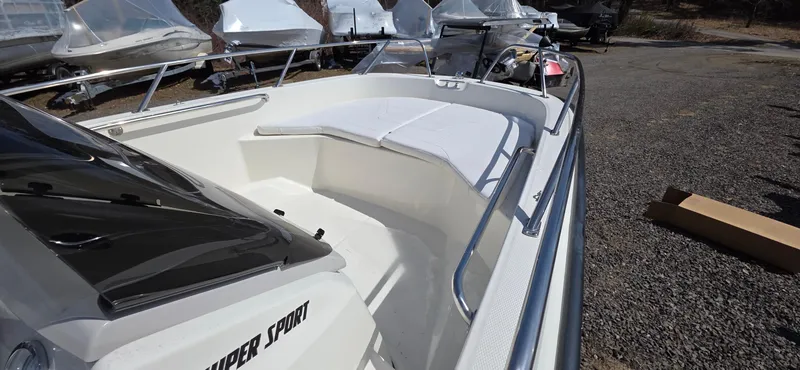 Slide: The Image of 2024 Boston Whaler 160 Super Sport boat, showcasing sleek design and spacious seating area. - 6