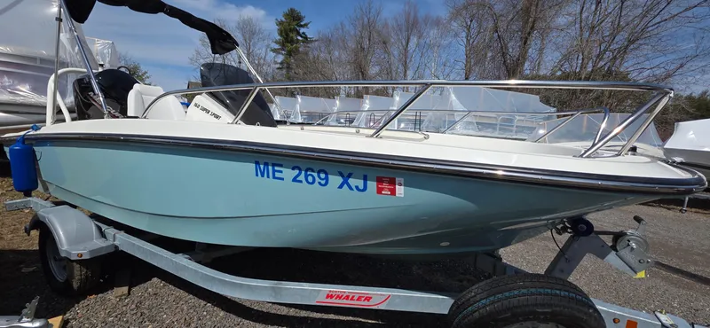 Slide: The Image of 2024 Boston Whaler 160 Super Sport boat on trailer, parked outdoors. - 7