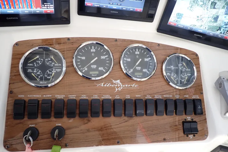 Slide: The Image of Instrument panel of a 1999 Albemarle 320 Express boat with gauges and switches. - 19