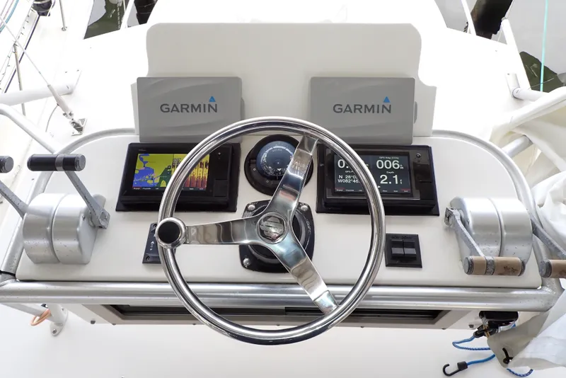 Slide: The Image of 1999 Albemarle 320 Express helm with Garmin navigation displays and steering wheel. - 22