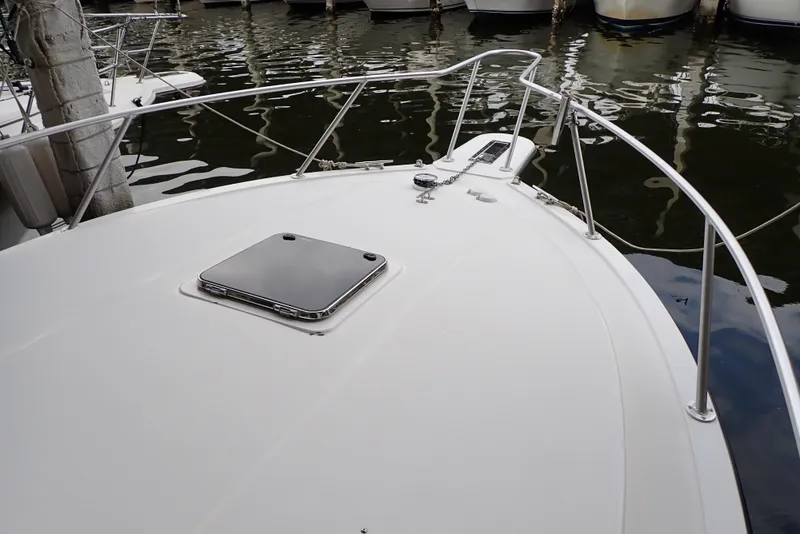 Slide: The Image of 1999 Albemarle 320 Express boat deck with railing and hatch, docked in marina. - 27