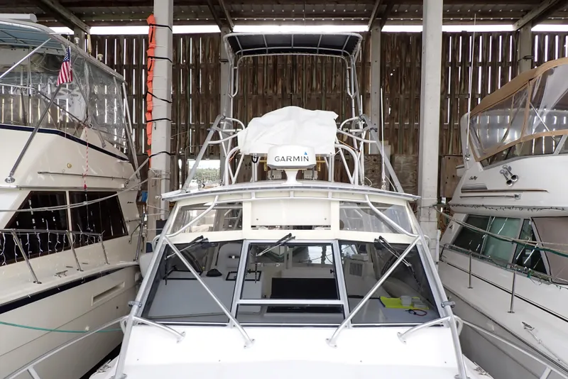 Slide: The Image of 1999 Albemarle 320 Express boat docked in a marina with other vessels. - 30