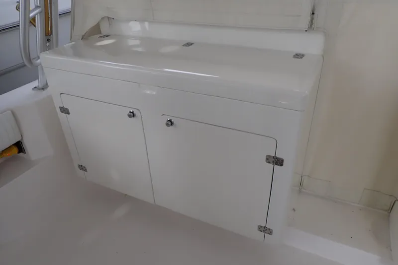 Slide: The Image of 1999 Albemarle 320 Express boat interior with white storage cabinet. - 33