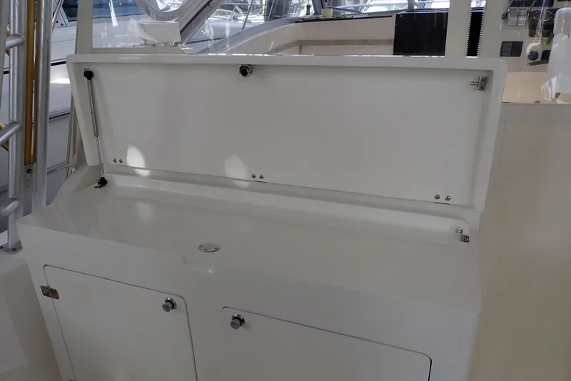 Slide: The Image of 1999 Albemarle 320 Express boat interior storage compartment with open lid. - 34