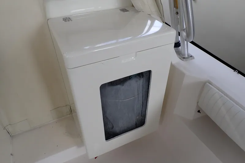 Slide: The Image of 1999 Albemarle 320 Express boat interior with a white storage compartment. - 36