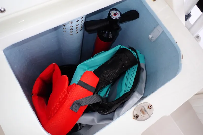 Slide: The Image of Storage compartment on a 1999 Albemarle 320 Express boat with life jackets and fire extinguisher. - 37