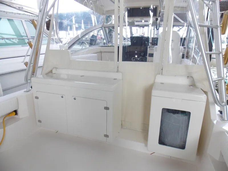 Slide: The Image of 1999 Albemarle 320 Express boat interior with storage cabinets and clean white surfaces. - 4