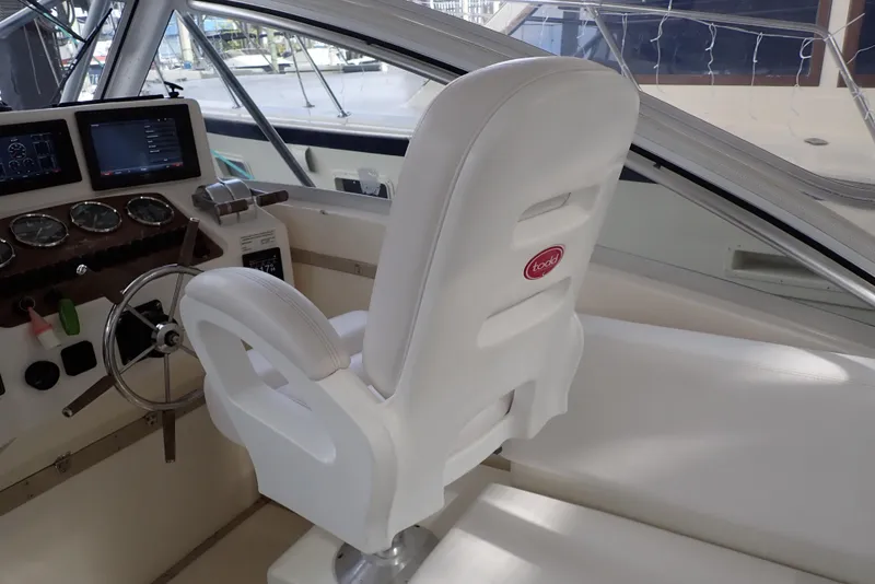 Slide: The Image of 1999 Albemarle 320 Express boat helm with white captain's chair and control panel. - 43