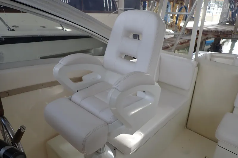 Slide: The Image of White captain's chair on 1999 Albemarle 320 Express boat, featuring cushioned armrests and backrest. - 44