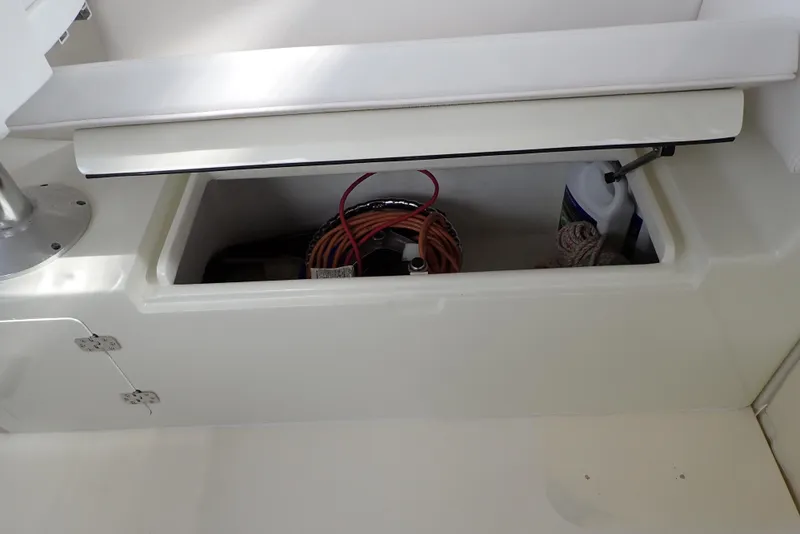 Slide: The Image of Storage compartment on a 1999 Albemarle 320 Express boat, containing coiled cables and equipment. - 46