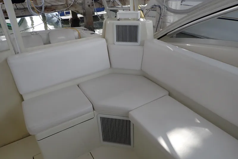 Slide: The Image of 1999 Albemarle 320 Express boat interior with white cushioned seating. - 47