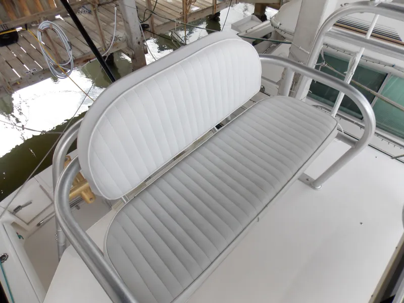 Slide: The Image of 1999 Albemarle 320 Express boat seat with white cushioned upholstery. - 9