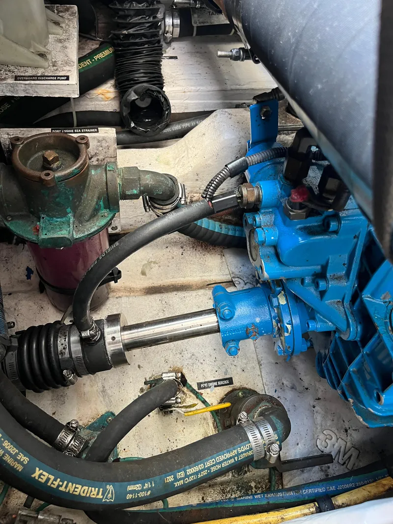 Slide: The Image of Engine compartment of a 2004 Tiara Yachts Classic, featuring mechanical components and hoses. - 10