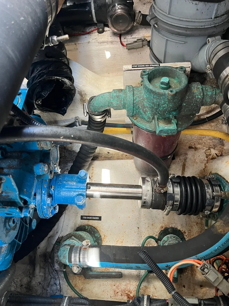 Slide: The Image of Engine compartment of a 2004 Tiara Yachts Classic, showcasing mechanical components and hoses. - 11