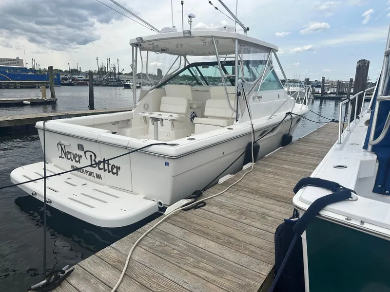 Slide: The Image of 2004 Tiara Yachts Classic docked at marina, overcast sky, named "Never Better," Harwich Port, MA. - 12