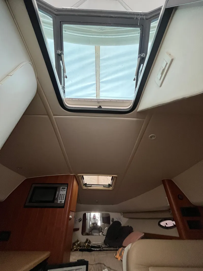 Slide: The Image of 2004 Tiara Yachts Classic interior with skylight and modern amenities. - 5
