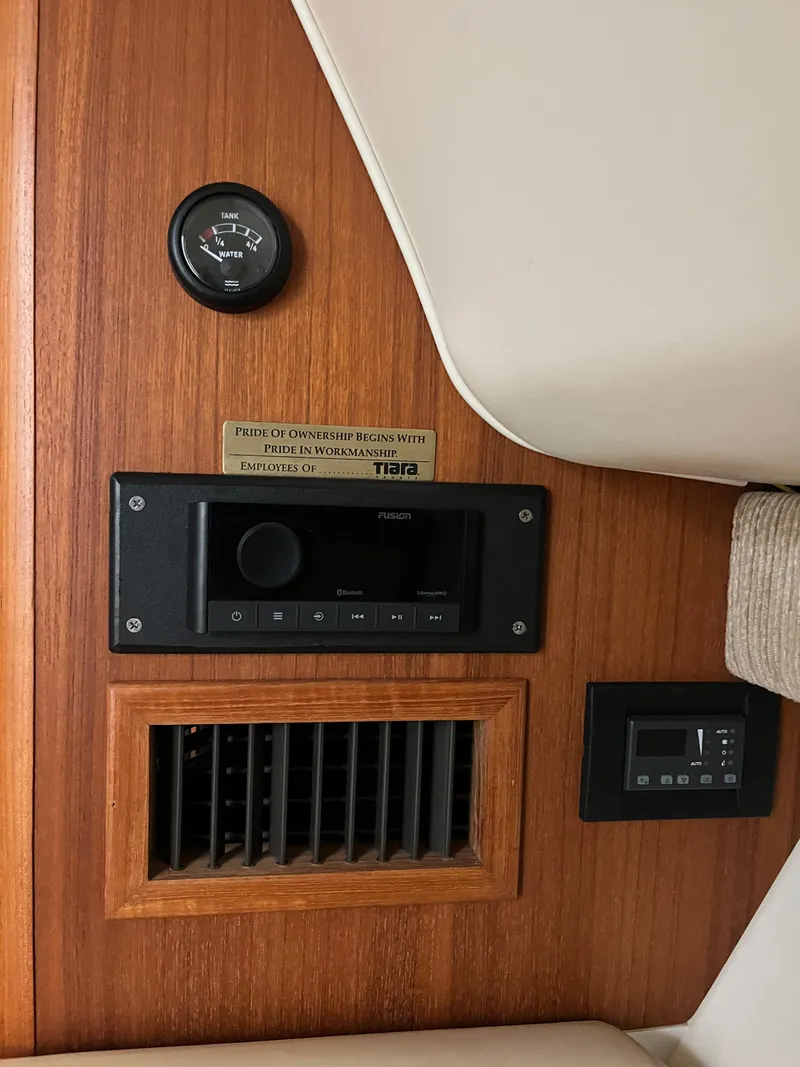 Slide: The Image of 2004 Tiara Yachts Classic interior with control panel and wood finish. - 7