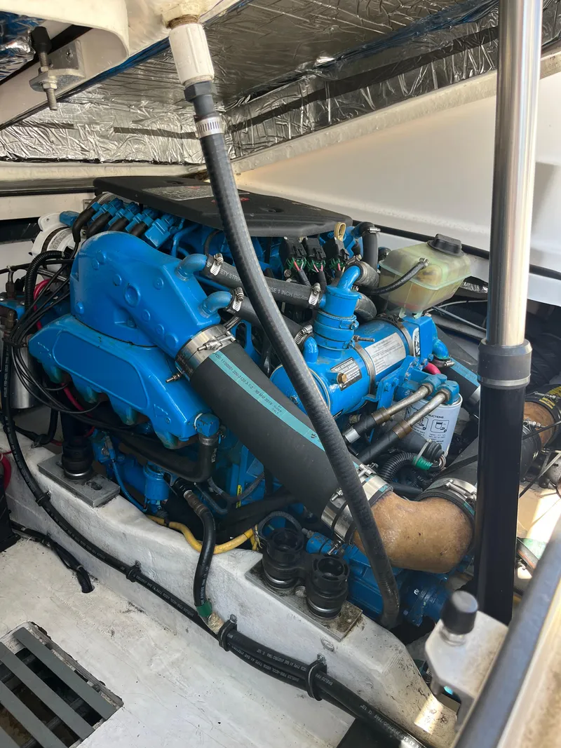 Slide: The Image of Engine compartment of a 2004 Tiara Yachts Classic, showcasing a blue marine engine. - 8