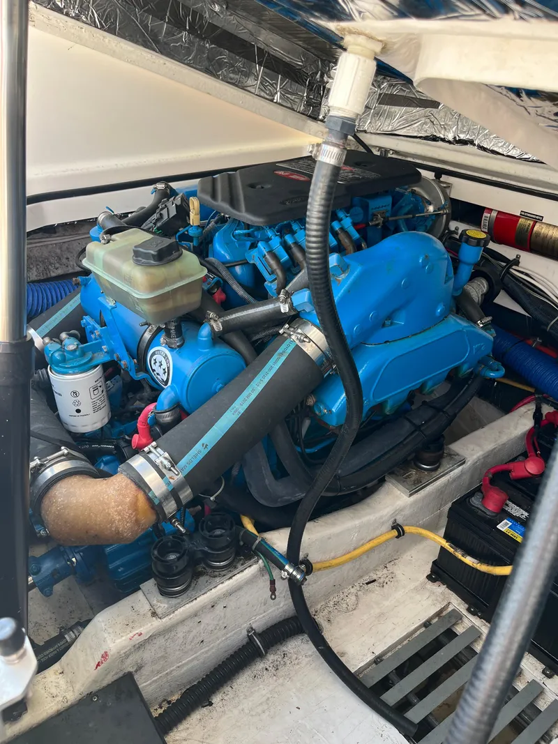 Slide: The Image of Engine compartment of a 2004 Tiara Yachts Classic, showcasing a well-maintained blue engine. - 9