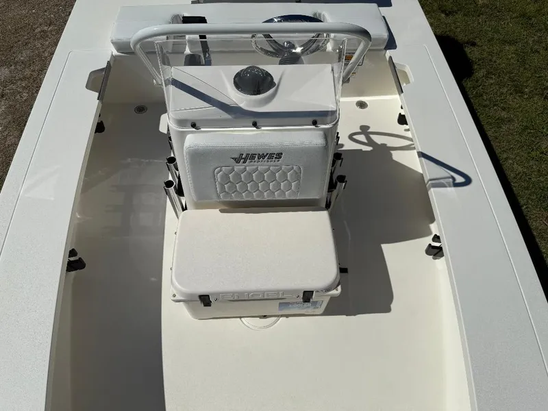 Slide: The Image of 2025 Hewes 16 Redfisher boat interior with steering console and seating. - 20