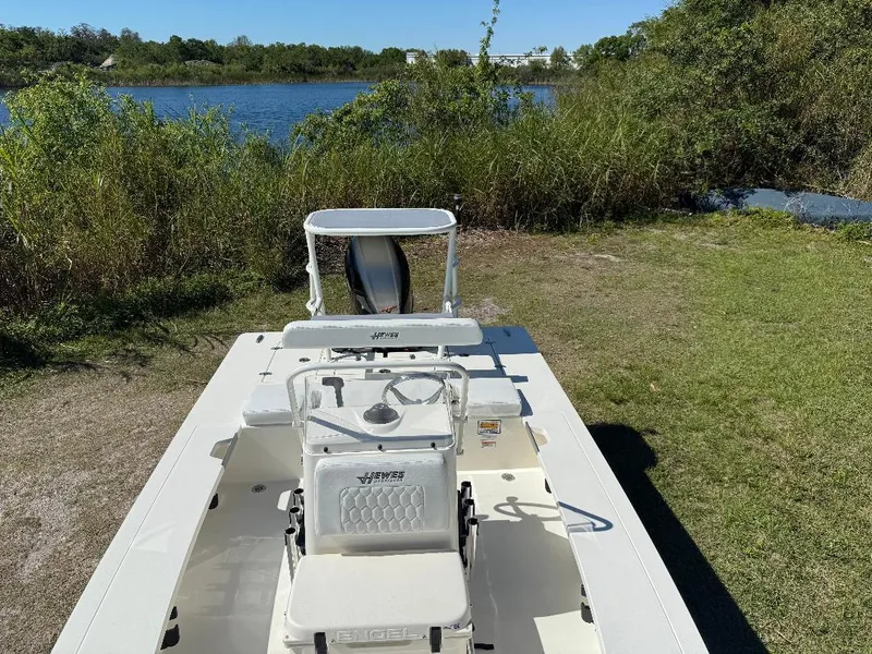 Slide: The Image of 2025 Hewes 16 Redfisher boat on grassy shore near a lake. - 21