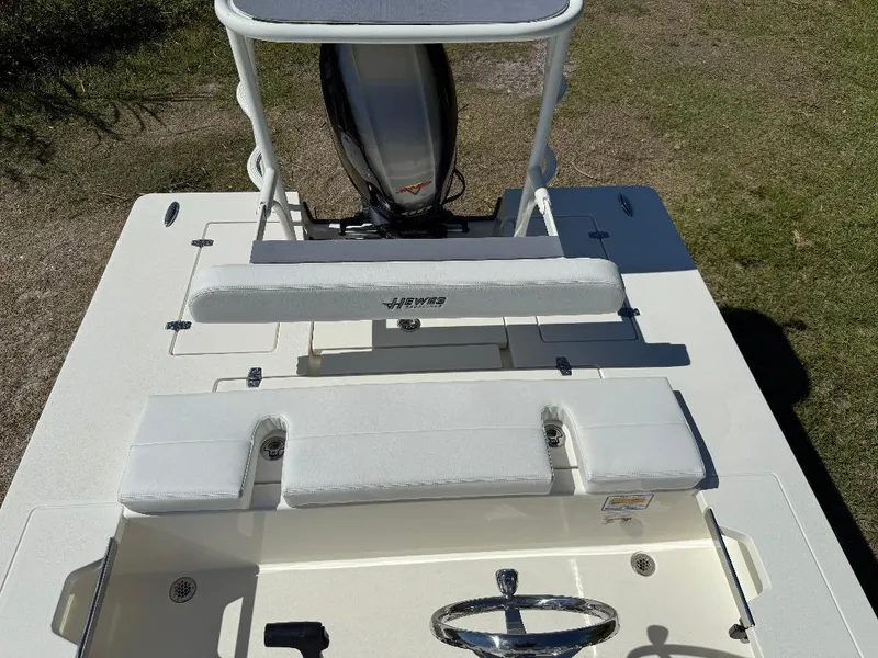Slide: The Image of 2025 Hewes 16 Redfisher boat interior with seating and steering wheel, viewed from above. - 22