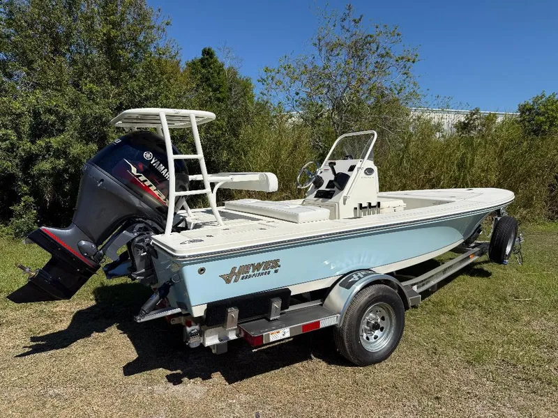 Slide: The Image of 2025 Hewes 16 Redfisher boat on trailer with Yamaha outboard motor, parked outdoors. - 24