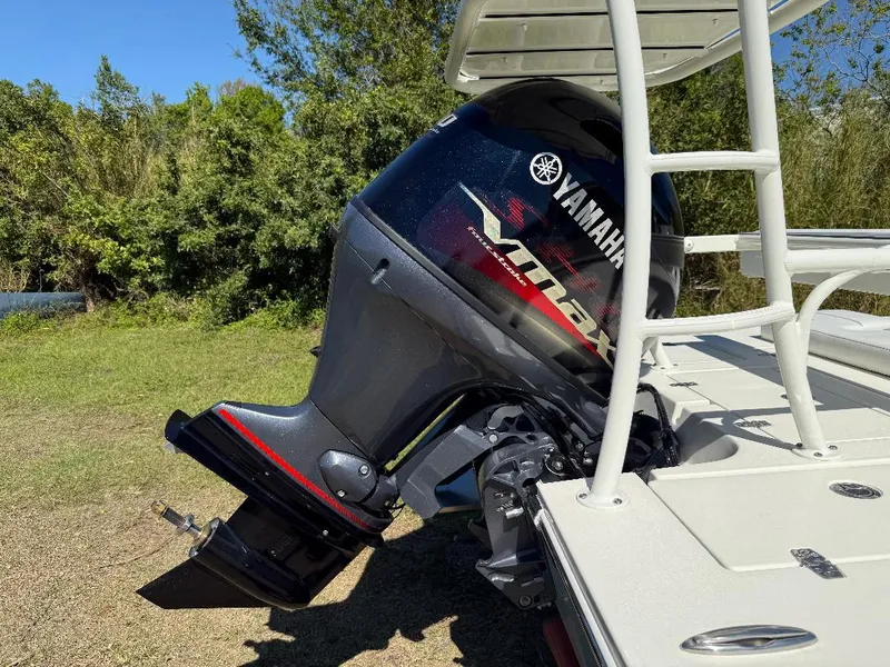Slide: The Image of 2025 Hewes 16 Redfisher boat with Yamaha VMAX outboard motor, parked on grass. - 27