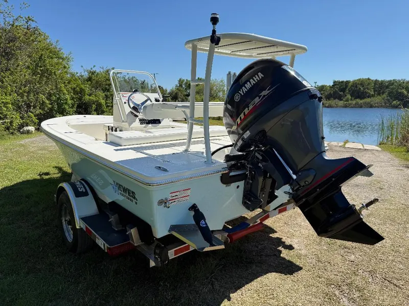 Slide: The Image of 2025 Hewes 16 Redfisher boat with Yamaha engine on a trailer by a lake. - 28