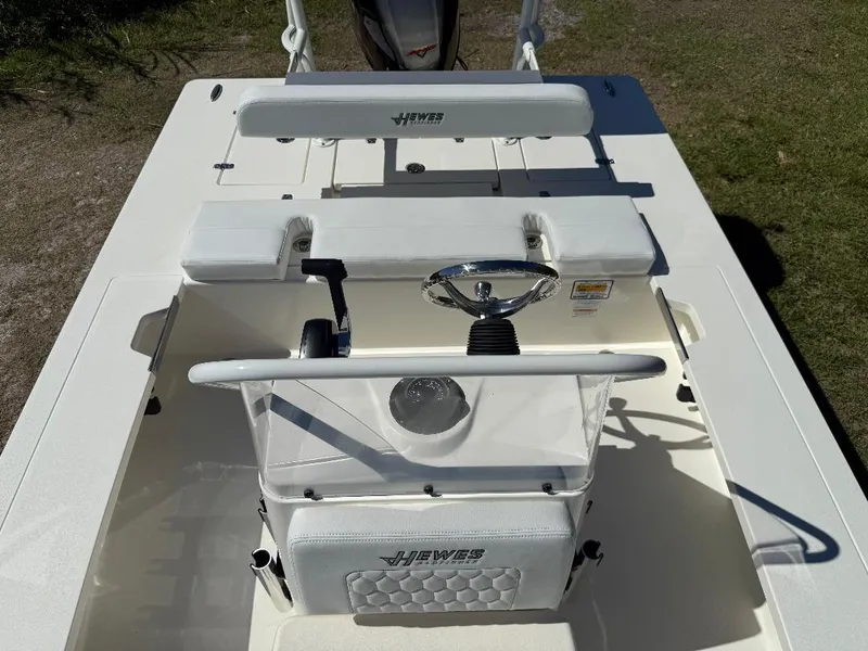 Slide: The Image of 2025 Hewes 16 Redfisher boat interior with steering wheel and seating. - 4