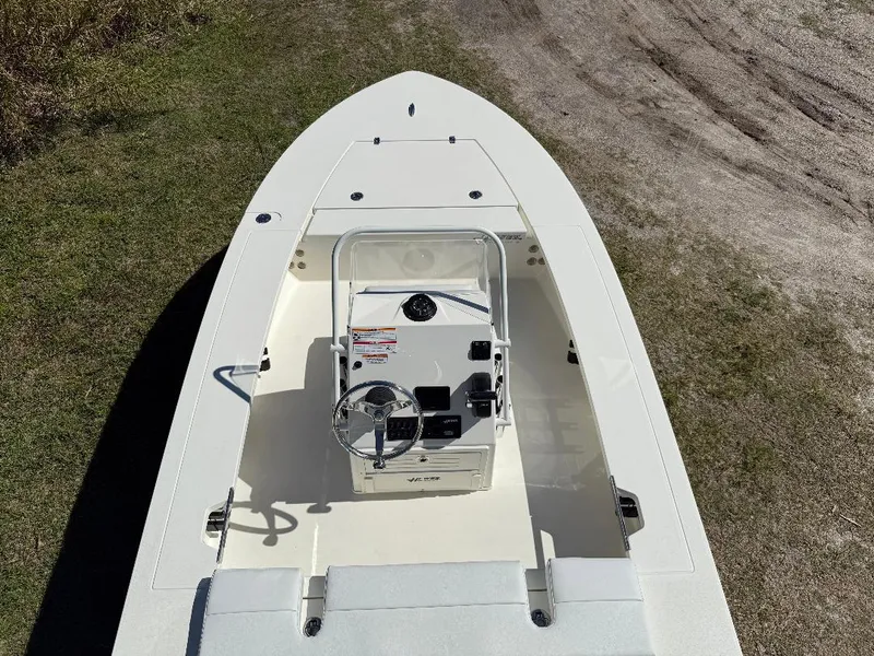 Slide: The Image of 2025 Hewes 16 Redfisher boat, top view, on grassy terrain. - 7