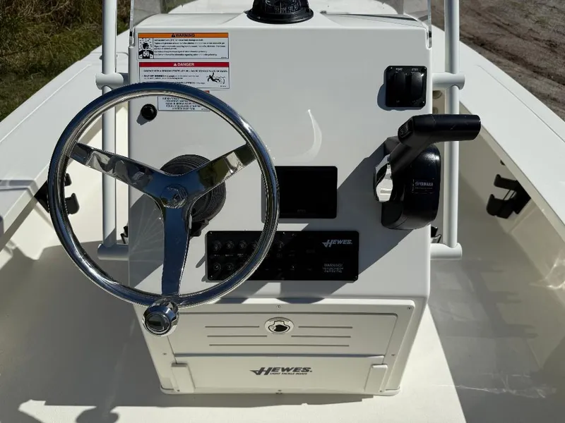 Slide: The Image of 2025 Hewes 16 Redfisher boat console with steering wheel and controls. - 9