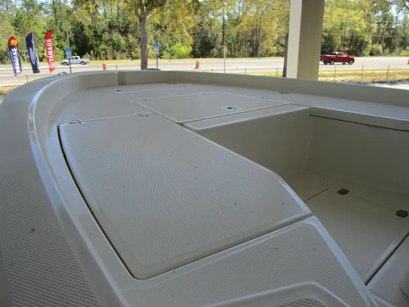 Slide: The Image of 2025 Pathfinder TRS 2200 boat deck with storage compartments, parked outdoors. - 10