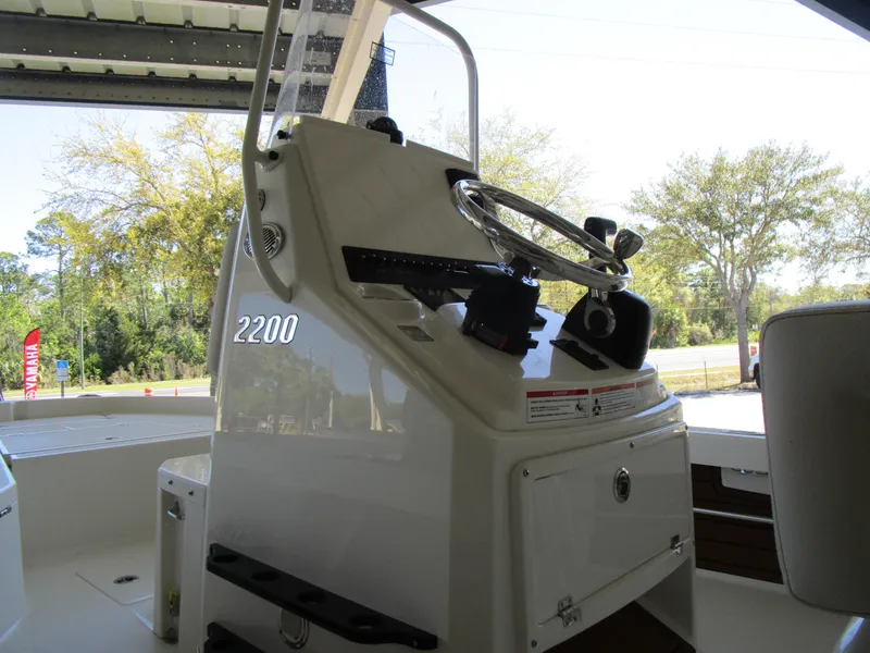 Slide: The Image of Pathfinder TRS 2200 boat console with steering wheel, 2025 model, outdoor setting. - 5