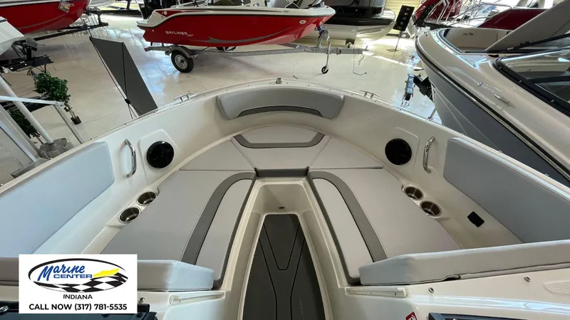 Slide: The Image of 2025 Bayliner V20i boat interior with seating, cup holders, and speakers at Marine Center Indiana. - 13
