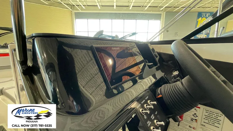 Slide: The Image of 2025 Bayliner V20i dashboard with steering wheel and control panel at Marine Center Indiana. - 8