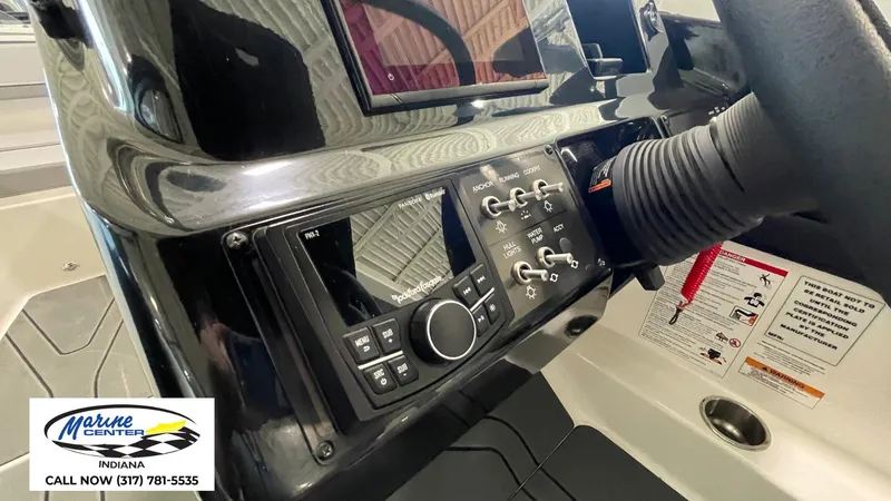 Slide: The Image of 2025 Bayliner V20i dashboard with control panel and audio system, Marine Center Indiana contact info. - 9