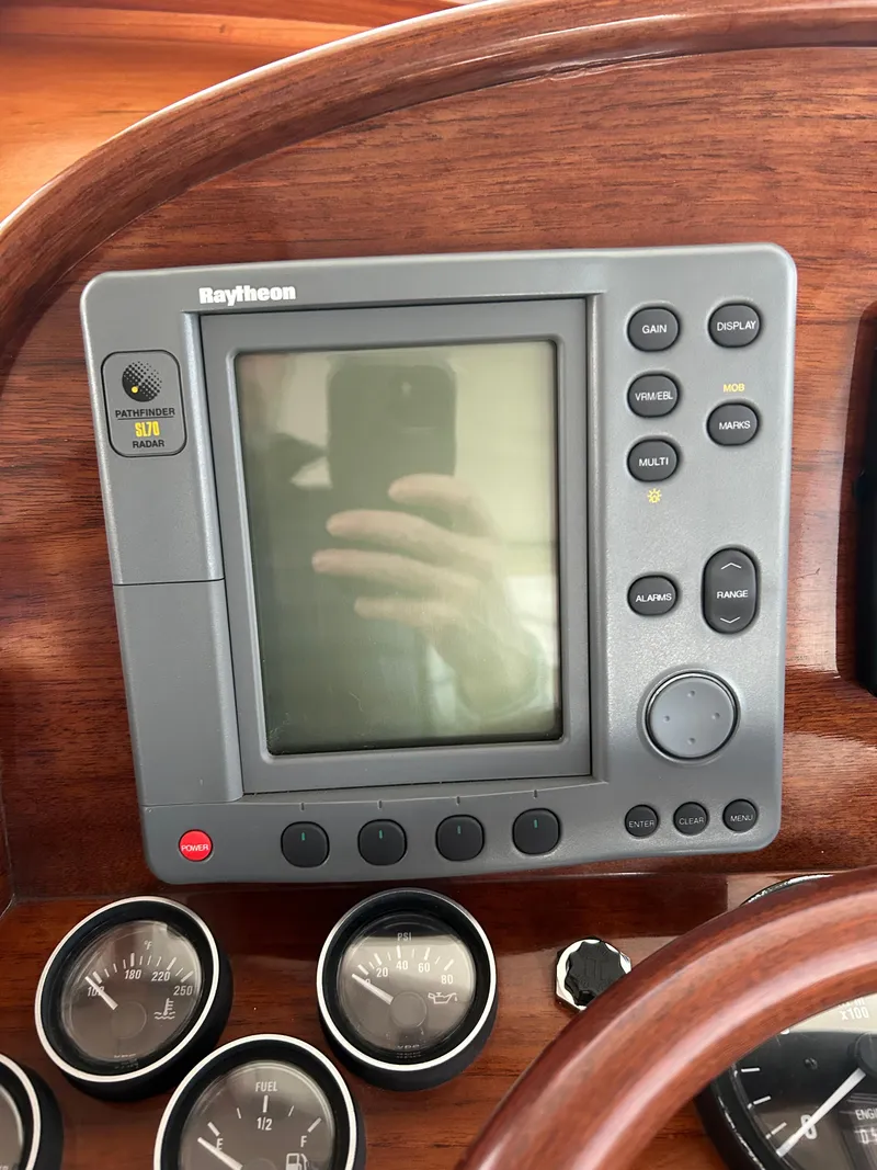 Slide: The Image of Hinckley Classic 36 Picnic Boat 2001 dashboard with Raytheon navigation system and gauges. - 21