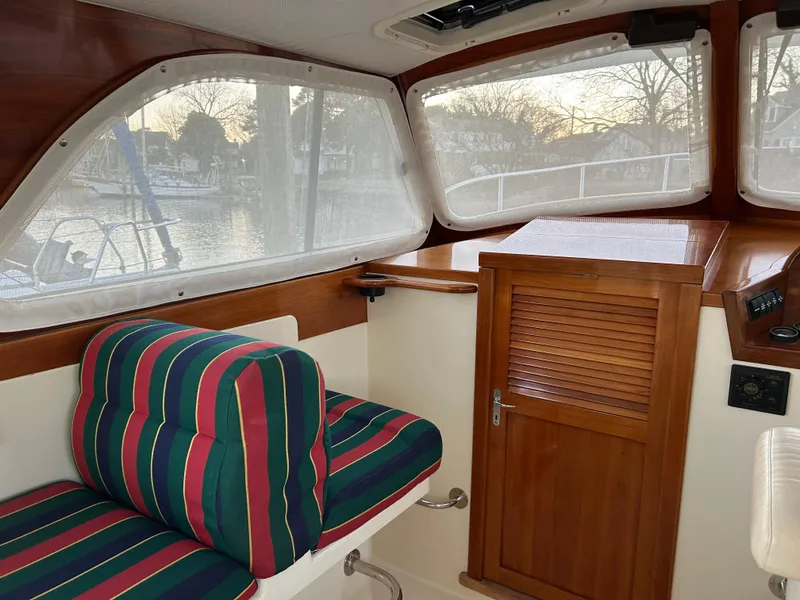 Slide: The Image of Interior of 2001 Hinckley Classic 36 Picnic Boat with striped seating and wooden cabinetry. - 30