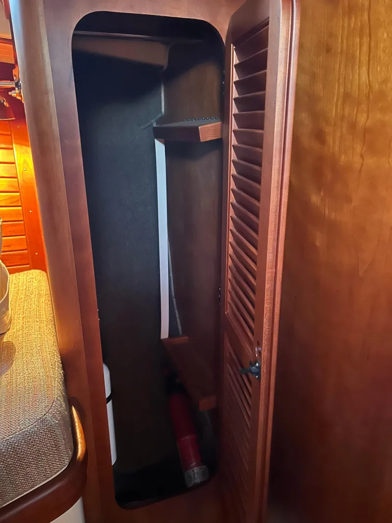 Slide: The Image of Wooden storage cabinet inside 2001 Hinckley Classic 36 Picnic Boat. - 40