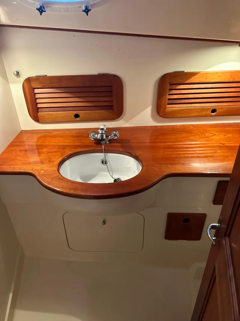 Slide: The Image of 2001 Hinckley Classic 36 Picnic Boat bathroom with wooden countertop and sink. - 47
