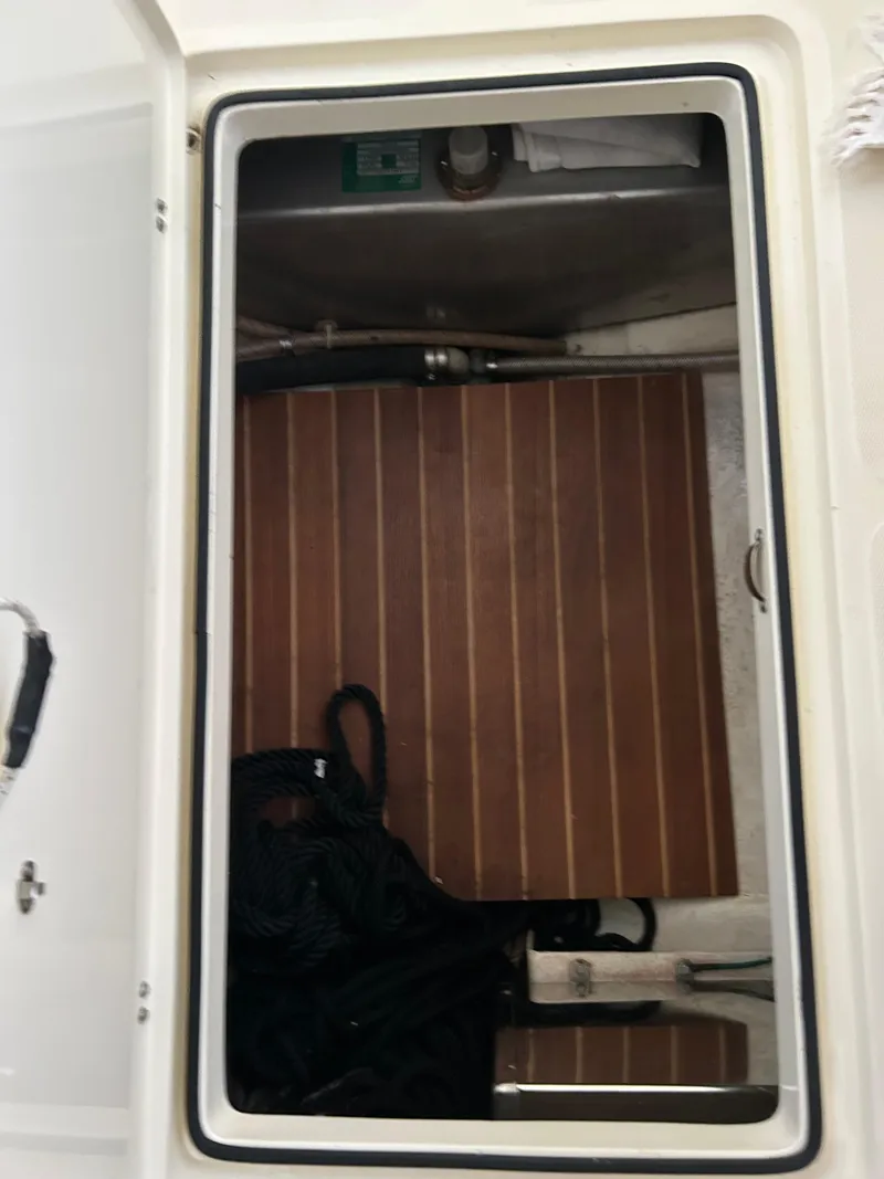 Slide: The Image of Storage compartment on a 2001 Hinckley Classic 36 Picnic Boat with wooden flooring. - 49