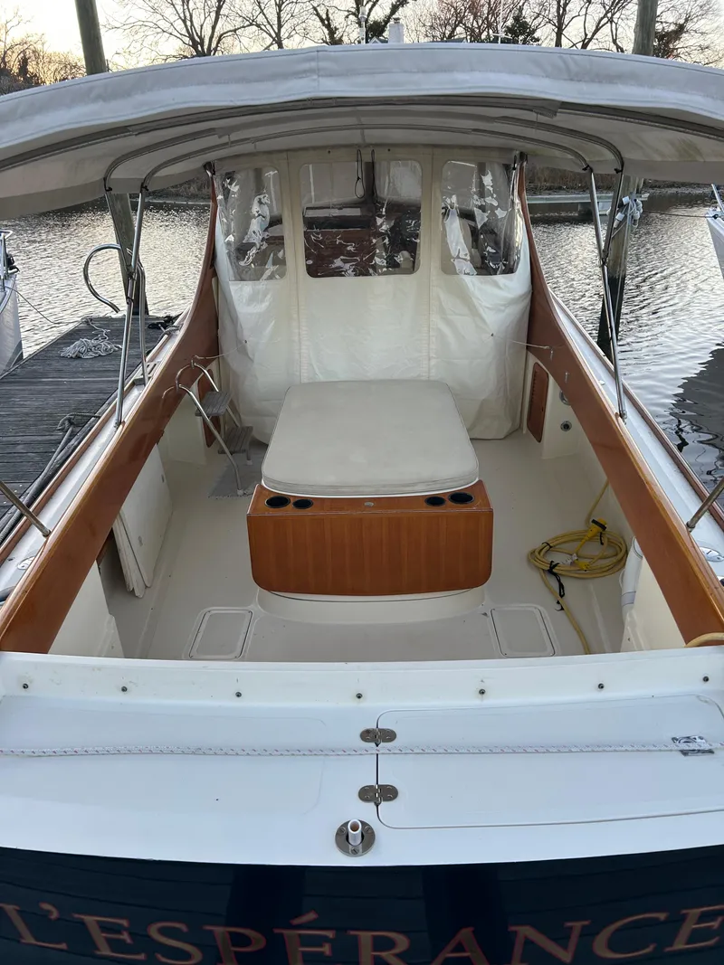 Slide: The Image of 2001 Hinckley Classic 36 Picnic Boat with covered seating area and wooden accents. - 8